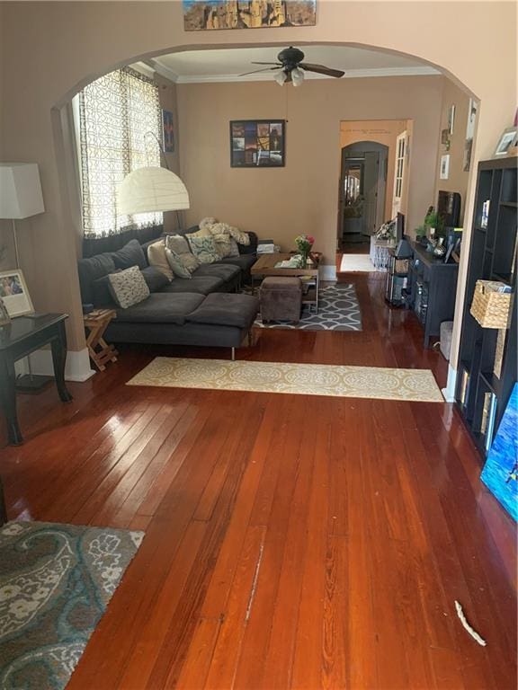 living room with hardwood / wood-style flooring, crown molding, and ceiling fan