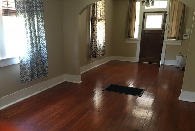 entryway with dark hardwood / wood-style flooring