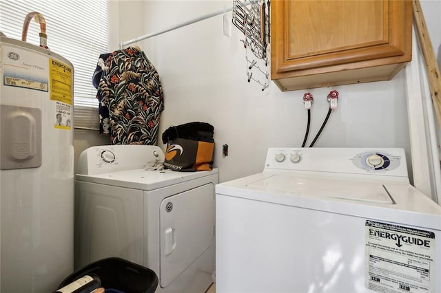 laundry room with cabinets, electric water heater, and washing machine and clothes dryer