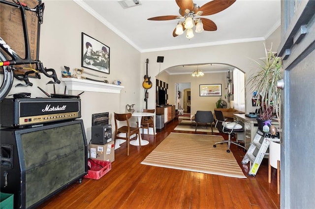 home office with ceiling fan with notable chandelier, hardwood / wood-style flooring, and crown molding