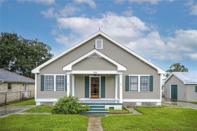 bungalow-style house with covered porch and a front lawn