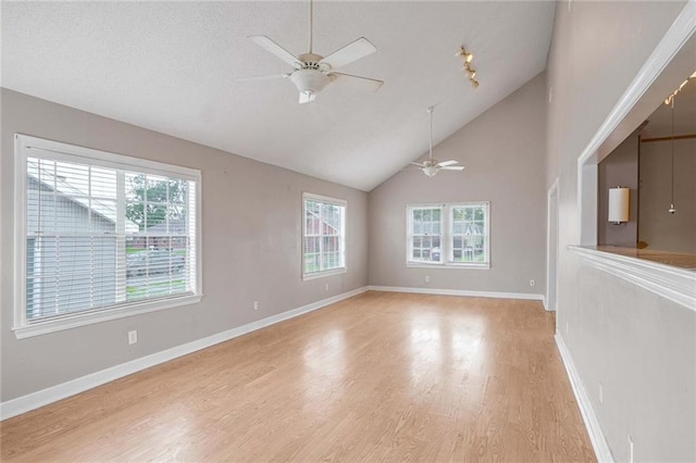 unfurnished room with vaulted ceiling, ceiling fan, and light hardwood / wood-style floors