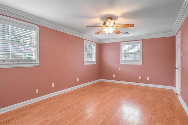 empty room featuring ornamental molding, ceiling fan, and light wood-type flooring