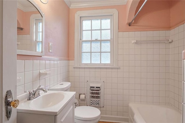 bathroom featuring toilet, heating unit, crown molding, tile walls, and vanity