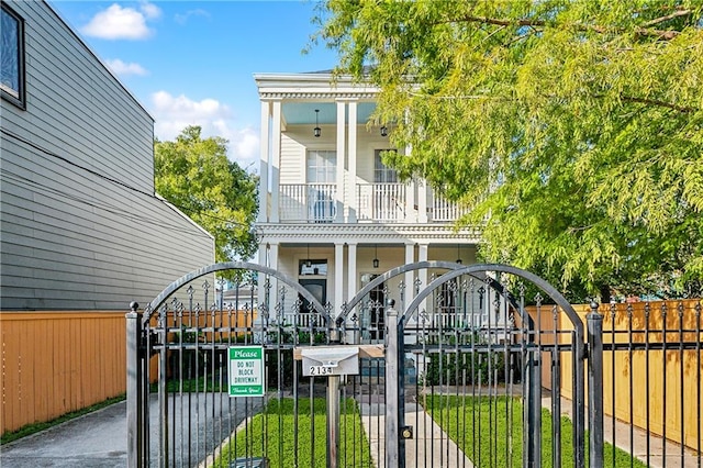 view of gate with a lawn