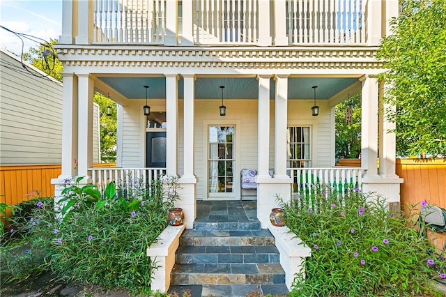 doorway to property featuring covered porch and a balcony