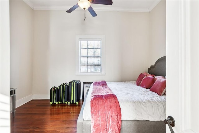 bedroom featuring dark wood-type flooring, ceiling fan, and crown molding