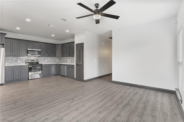 kitchen featuring gray cabinets, light hardwood / wood-style flooring, and stainless steel appliances