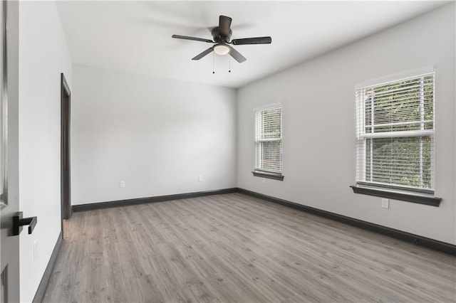 unfurnished room with light wood-type flooring and ceiling fan