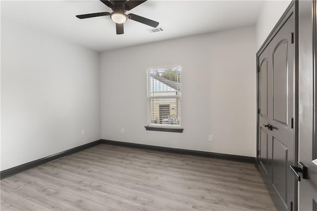 empty room featuring ceiling fan and light wood-type flooring