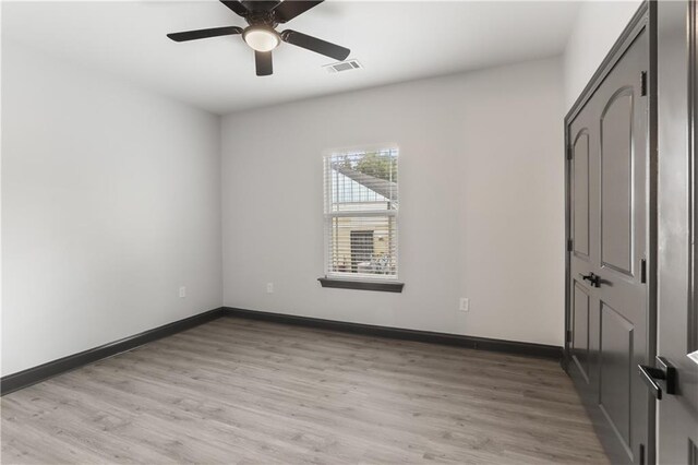 3227 Toledano St, New Orleans, LA 70125 - unfurnished bedroom featuring light wood-type flooring, baseboards, and a ceiling fan