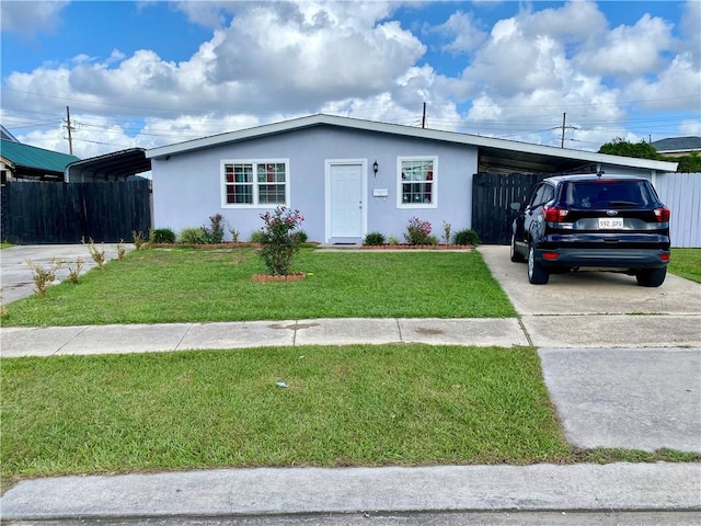 ranch-style home with a carport and a front lawn