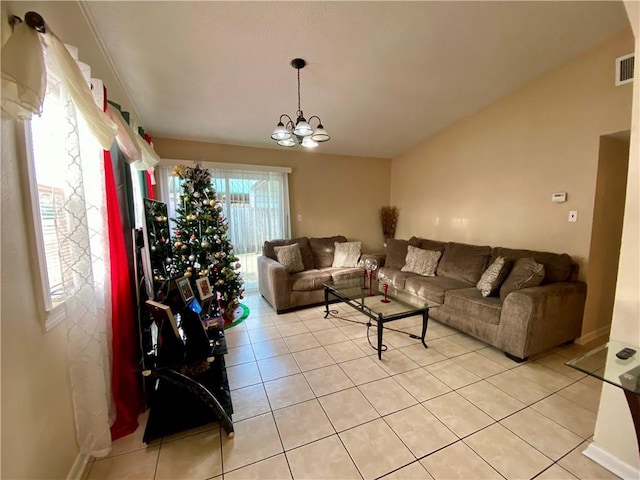 tiled living room featuring an inviting chandelier