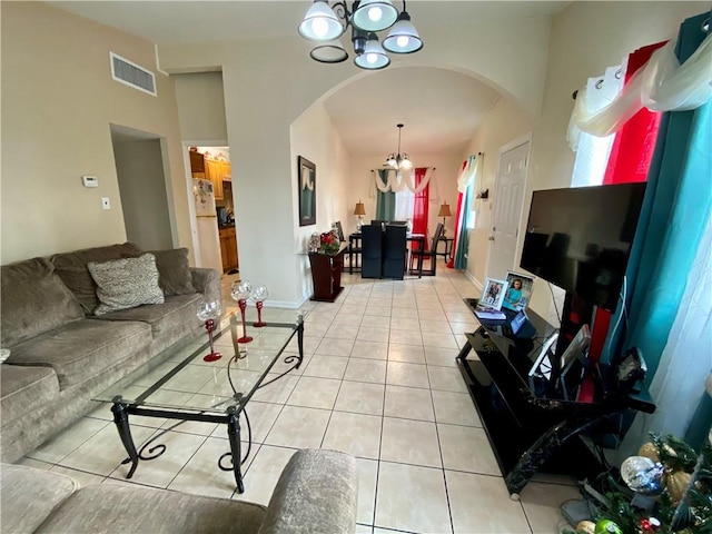 living room featuring a chandelier and light tile patterned floors