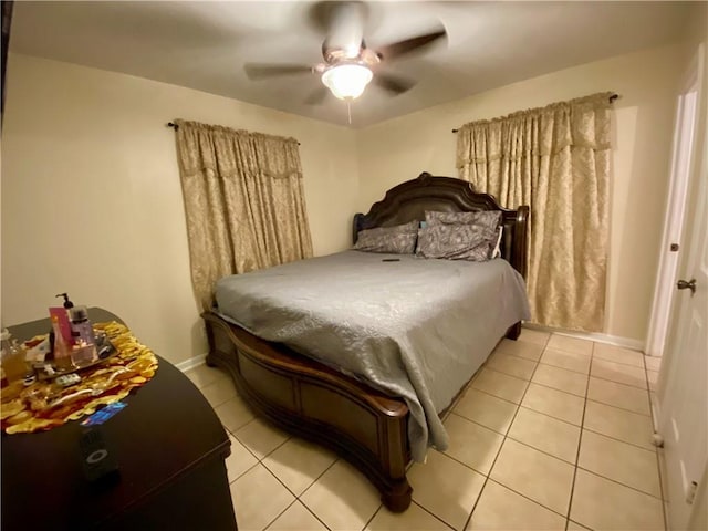 tiled bedroom featuring ceiling fan