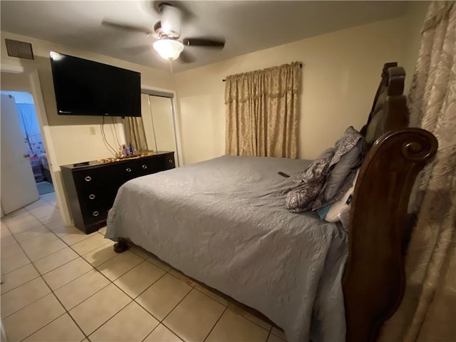 tiled bedroom featuring ceiling fan