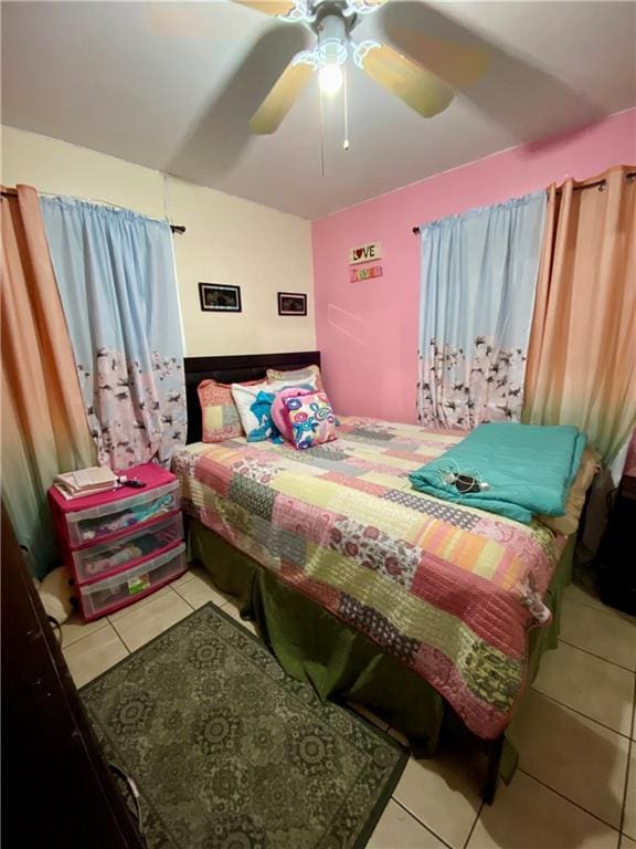 bedroom featuring light tile patterned flooring and ceiling fan