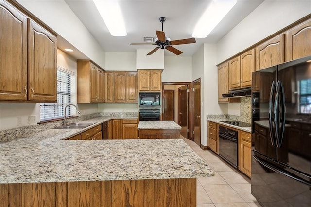 kitchen featuring black appliances, a kitchen island, light tile patterned floors, sink, and ceiling fan