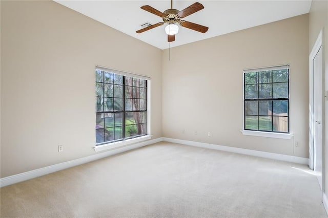 unfurnished room with light colored carpet and a healthy amount of sunlight