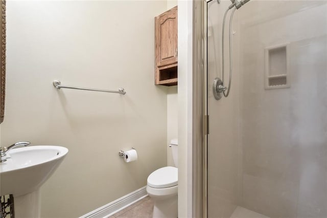 bathroom with a shower with door, tile patterned floors, toilet, and sink