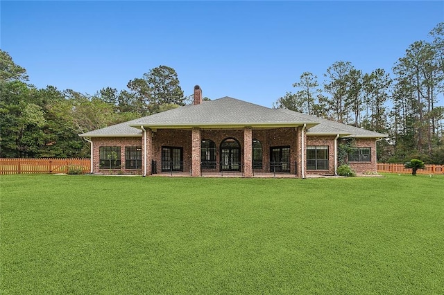 rear view of house featuring a yard and a patio area