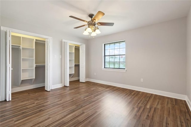 unfurnished bedroom with ceiling fan and dark hardwood / wood-style flooring