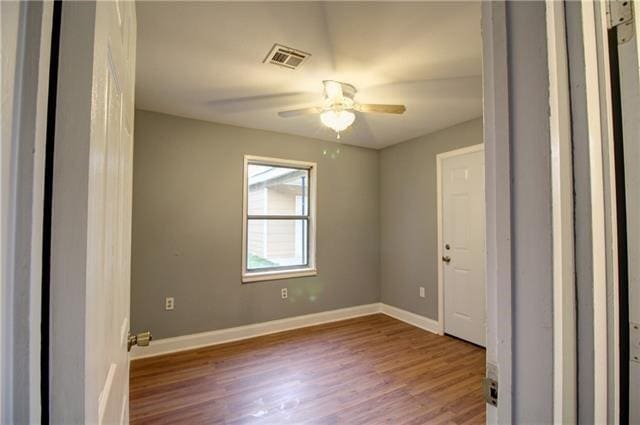 spare room featuring hardwood / wood-style floors and ceiling fan