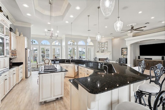 kitchen with a breakfast bar area, pendant lighting, and a large island