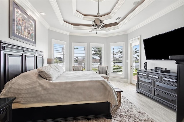 bedroom featuring ornamental molding, access to exterior, light hardwood / wood-style floors, and a raised ceiling