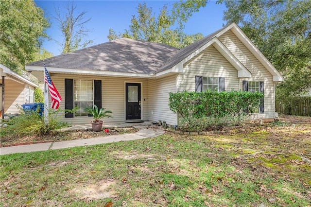 view of front of house with a front yard and covered porch