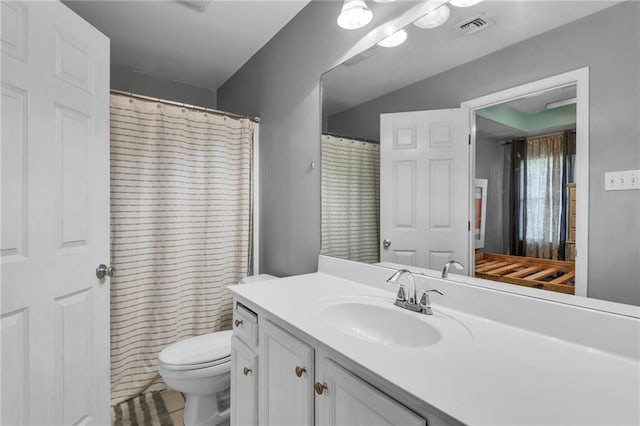 bathroom featuring toilet and vanity