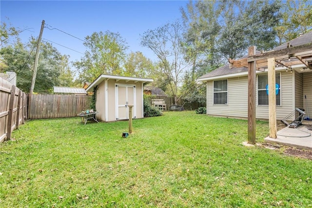 view of yard featuring a patio and a storage shed