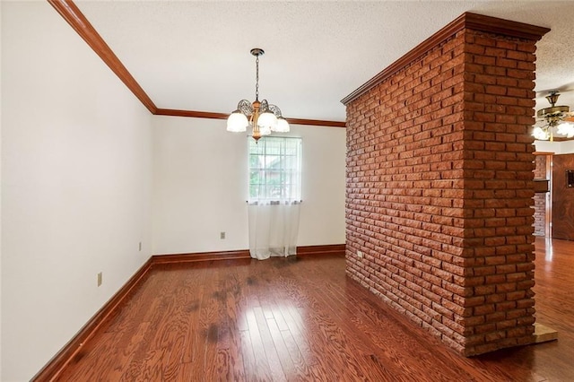 unfurnished dining area with dark wood-type flooring, ornamental molding, and a textured ceiling