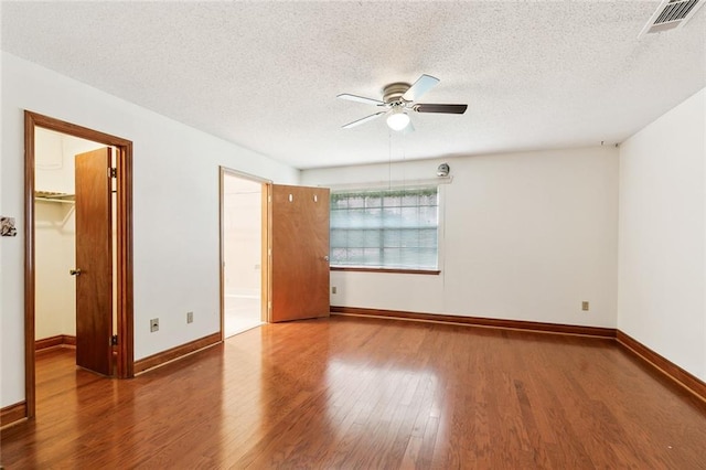 unfurnished room featuring wood-type flooring, ceiling fan, and a textured ceiling