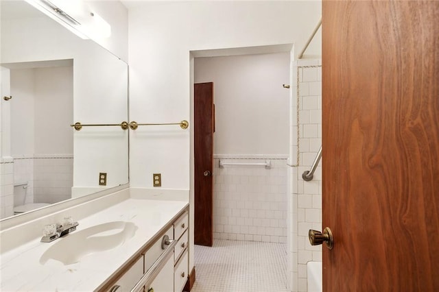 bathroom featuring vanity, tile walls, tile patterned floors, and  shower combination