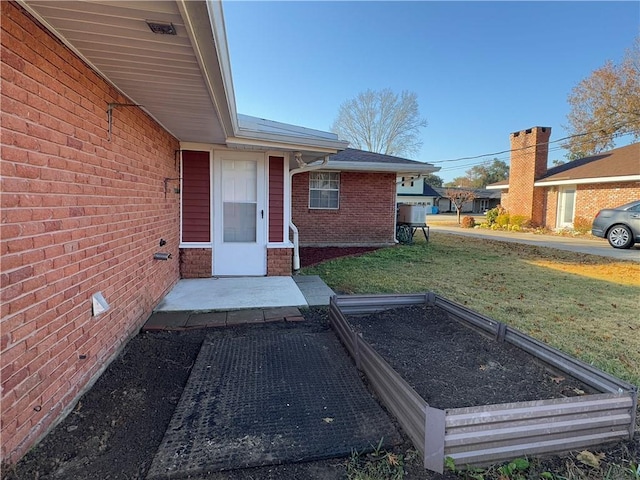 view of exterior entry with a yard