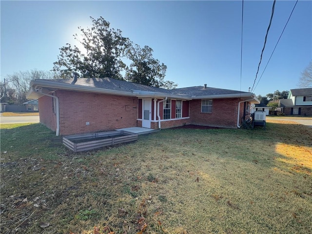 rear view of property with a yard