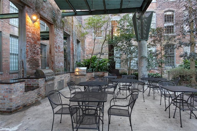 view of patio featuring an outdoor kitchen and a grill