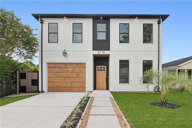 view of front facade with a garage and a front lawn