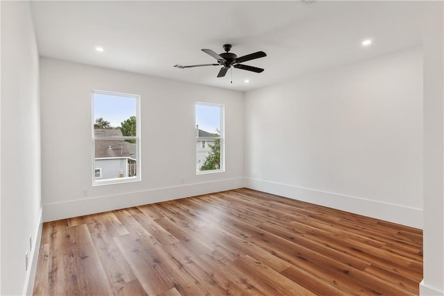 unfurnished room featuring ceiling fan and light wood-type flooring