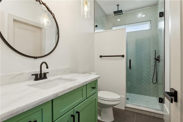 bathroom featuring tile patterned flooring, vanity, a shower with door, and toilet