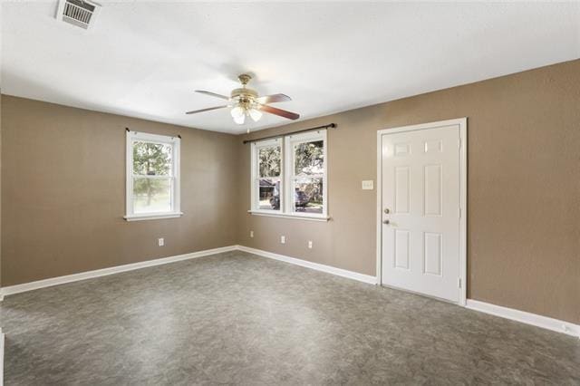 carpeted empty room featuring ceiling fan