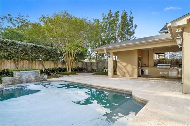 view of swimming pool with area for grilling and a patio