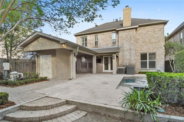 back of house featuring central AC and a patio