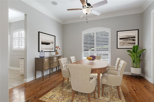 dining room featuring light hardwood / wood-style flooring, ceiling fan, and crown molding