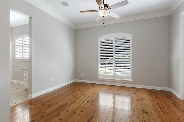 unfurnished room featuring ceiling fan, light wood-type flooring, and ornamental molding