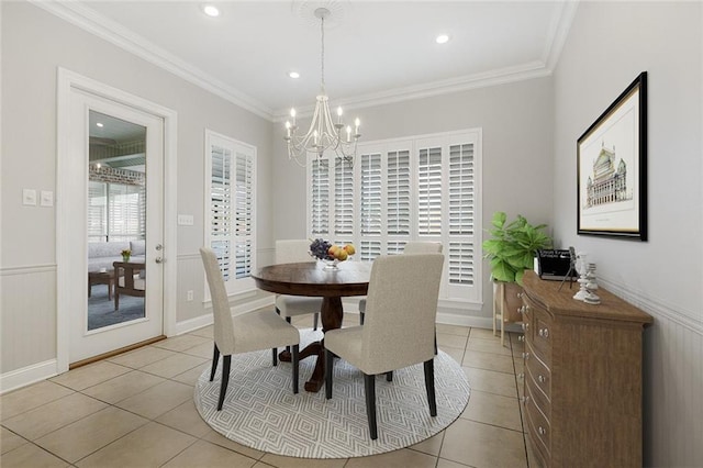 tiled dining room with a chandelier and ornamental molding