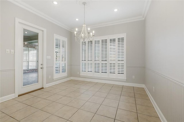 tiled spare room with a chandelier and ornamental molding