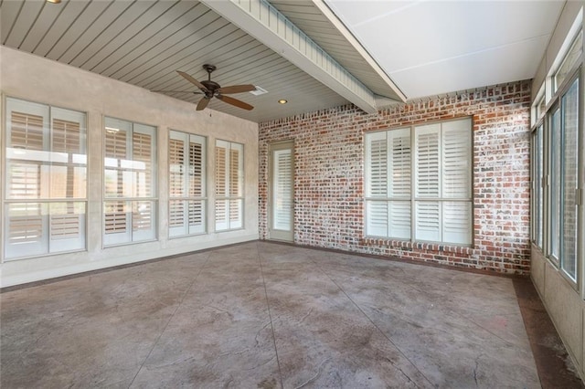 unfurnished sunroom with ceiling fan