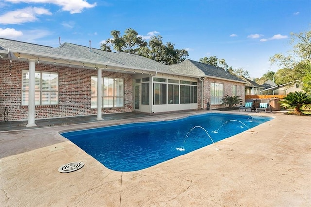 view of swimming pool with a patio area and pool water feature